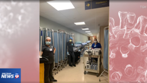 Three EVS workers wearing PPE in hallway